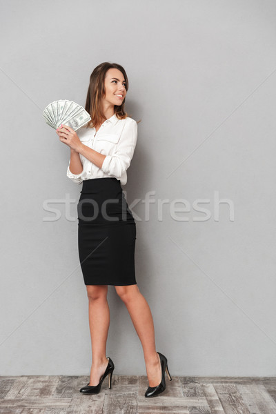 Opgewonden jonge zakenvrouw naar geld Stockfoto © deandrobot