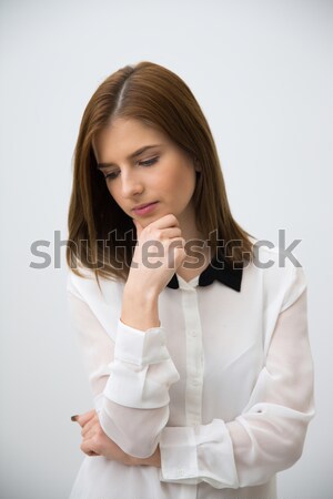 Smiling woman standing and looking away on gray background Stock photo © deandrobot