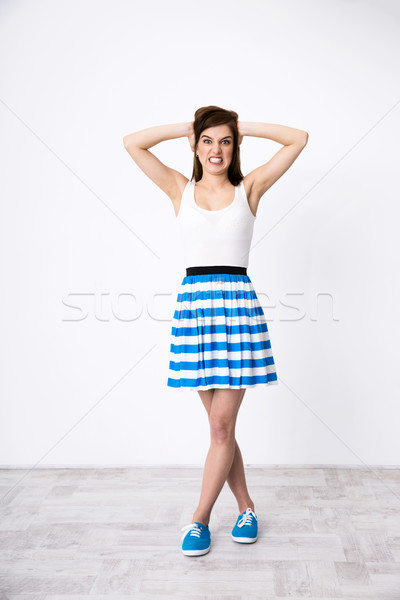 Full length portrait of angry woman covering ears Stock photo © deandrobot