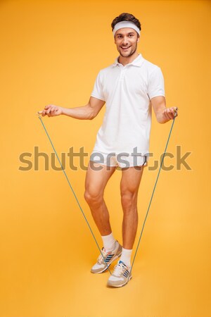 Yakışıklı adam atlama halat tam uzunlukta portre yalıtılmış Stok fotoğraf © deandrobot