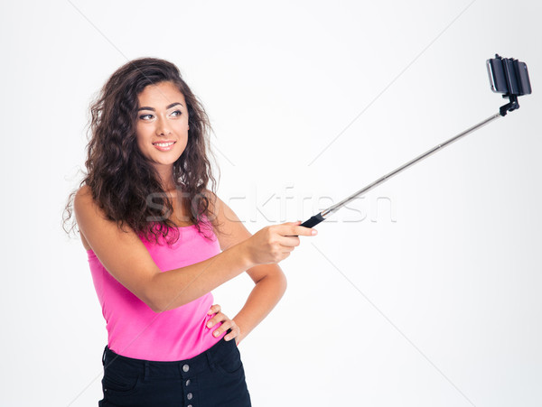 Smiling young woman making selfie photo Stock photo © deandrobot