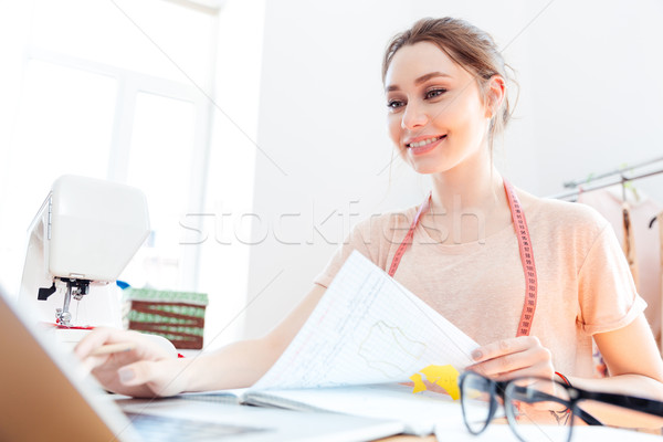 Portrait of happy woman seamstress at work Stock photo © deandrobot