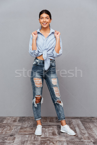 Full length portrait of a casual beautiful woman posing Stock photo © deandrobot