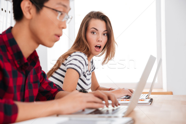 Students who were surprised from what was seen in laptops Stock photo © deandrobot