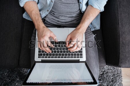 Adam dizüstü bilgisayar üst görmek gündelik oturma Stok fotoğraf © deandrobot