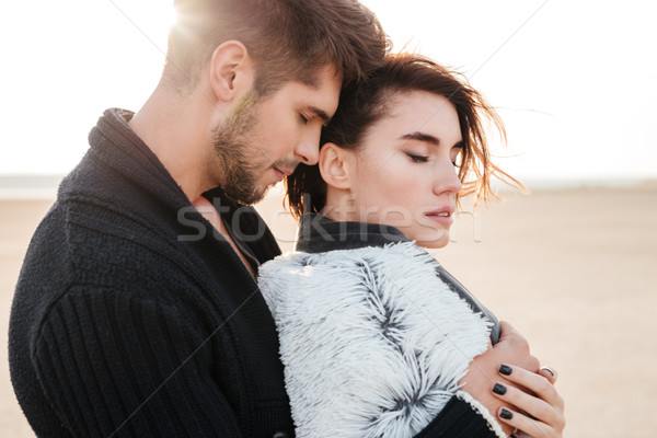 Beautiful tender couple in love hugging on the beach Stock photo © deandrobot