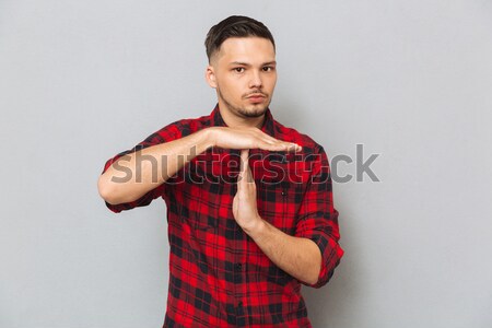 Man in shirt showing timeout Stock photo © deandrobot