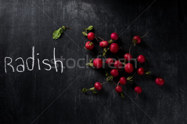 Picture of a radish over dark chalkboard background Stock photo © deandrobot
