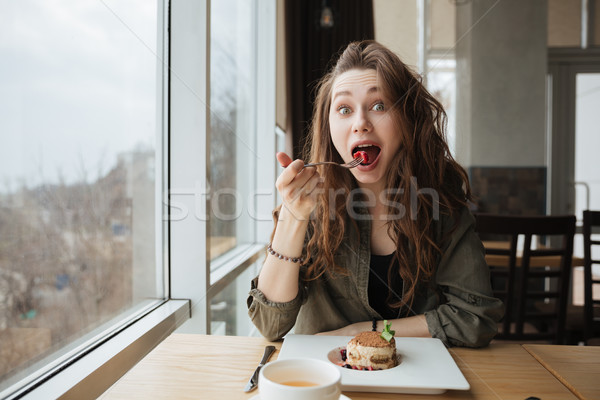 Portrait of eating woman Stock photo © deandrobot