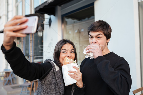 Stock photo: Man and woman making photo on smartphone