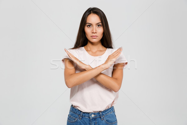 Portrait of a serious concentrated asian woman standing Stock photo © deandrobot