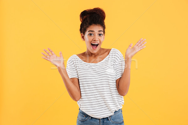 Happy young woman with opened mouth smiling and looking camera isolated Stock photo © deandrobot