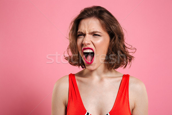 Close up portrait of a furious pretty woman Stock photo © deandrobot