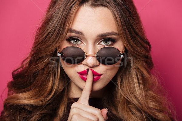 Close up portrait of a confident pretty girl Stock photo © deandrobot