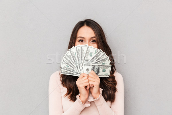 Image of lucky happy woman with long hair covering her face with Stock photo © deandrobot