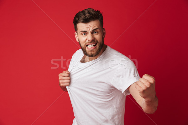 Angry emotional young man looking camera. Stock photo © deandrobot