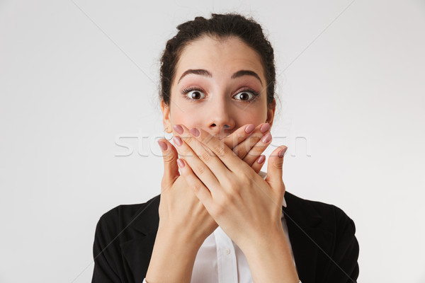 Young business woman covering mouth with hands Stock photo © deandrobot
