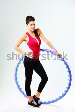 Young cheerful sport woman holding a massage hoop over white background Stock photo © deandrobot