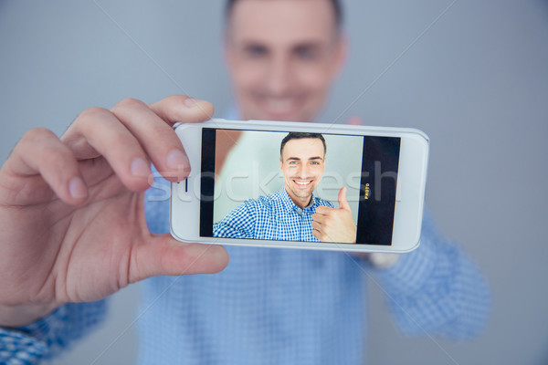 Stock photo: Smiling man making selfie photo