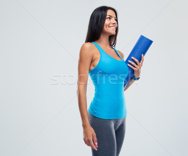 Stock photo: Cheerful sports woman holding yoga mat