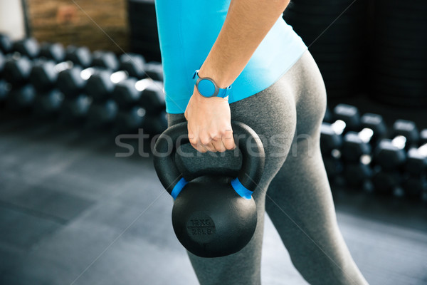 Woman working out with kettle ball Stock photo © deandrobot