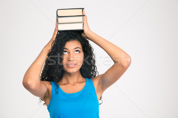 Afro american woman holding books on the head  Stock photo © deandrobot