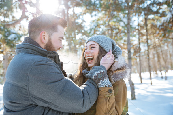 Couple standing together in winter park Stock photo © deandrobot