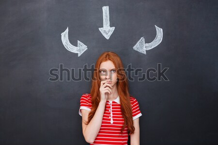 Amusing woman standing over chalkboard with drawn devils horns  Stock photo © deandrobot