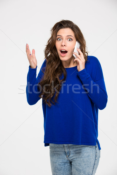 Stock photo: Amazed woman talking on the phone