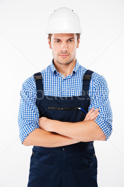 Serious man foreman in hard hat standing with handsom folded Stock photo © deandrobot
