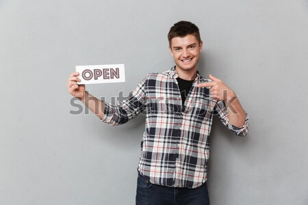 Portret glimlachend brunette man wijzend vinger Stockfoto © deandrobot