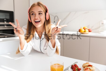 Attractive beautiful lady sitting in cafe and looking at mirror. Stock photo © deandrobot