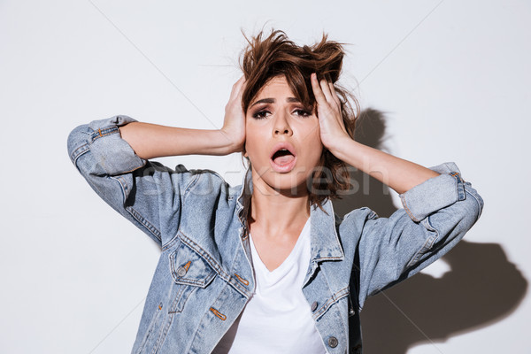 Shocked woman isolated on a white background. Stock photo © deandrobot