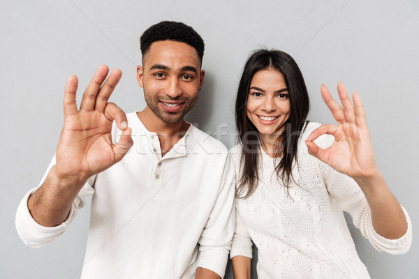 Stock photo: Happy loving couple showing okay gesture