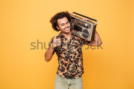 Pretty retro woman holding boombox. Stock photo © deandrobot