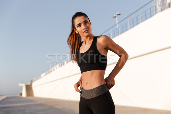 Serious fitness lady with beautiful healthy body looking camera Stock photo © deandrobot