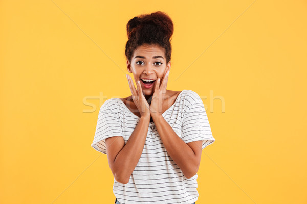Meglepődött boldog hölgy göndör haj tart arc Stock fotó © deandrobot