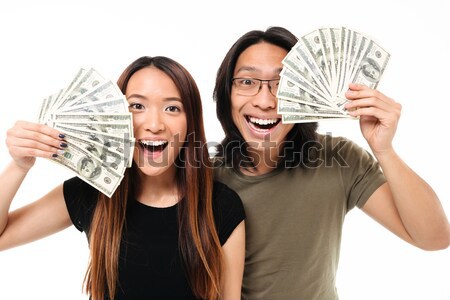 Two cheerful women covering their half faces Stock photo © deandrobot