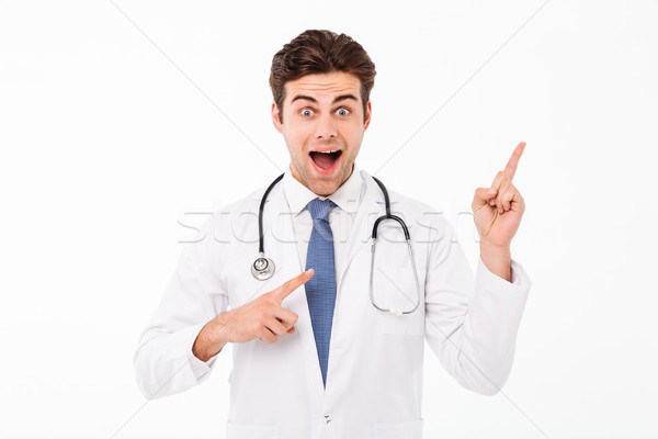 портрет счастливым привлекательный мужской доктор равномерный указывая Сток-фото © deandrobot