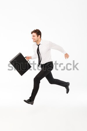 Full length portrait of a cheerful handsome businessman Stock photo © deandrobot