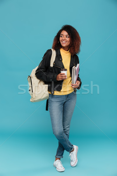 Full length image of smiling african woman in leather jacket Stock photo © deandrobot