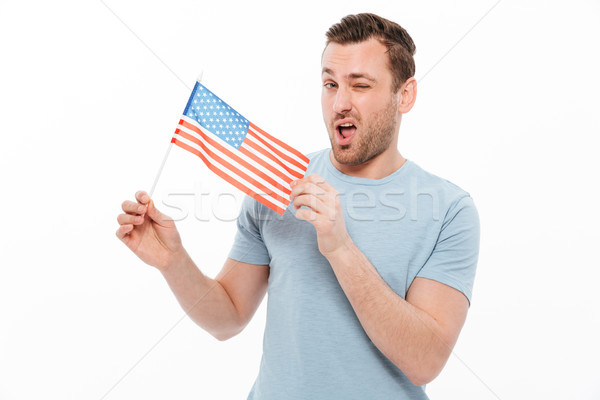 Fotografia atrakcyjny człowiek jeżyć mały amerykańską flagę Zdjęcia stock © deandrobot