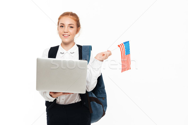 Smiling gigner student woman with backpack holding laptop computer Stock photo © deandrobot