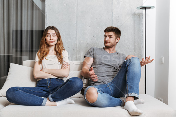 Confused young couple having an argument Stock photo © deandrobot