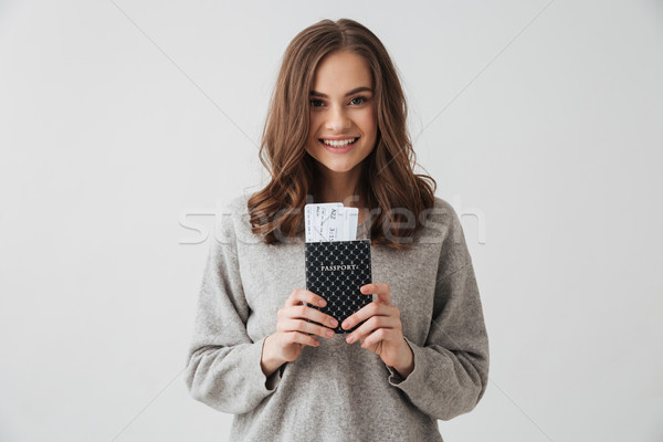 Smiling brunette woman in sweater preparing to trip Stock photo © deandrobot