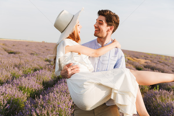 Cheerful young couple having fun at the lavender field Stock photo © deandrobot