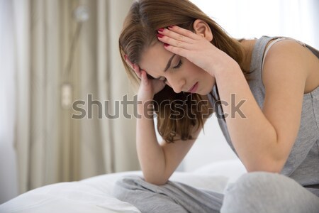 Fiatal nő tart fej fájdalom szenvedés fejfájás Stock fotó © deandrobot
