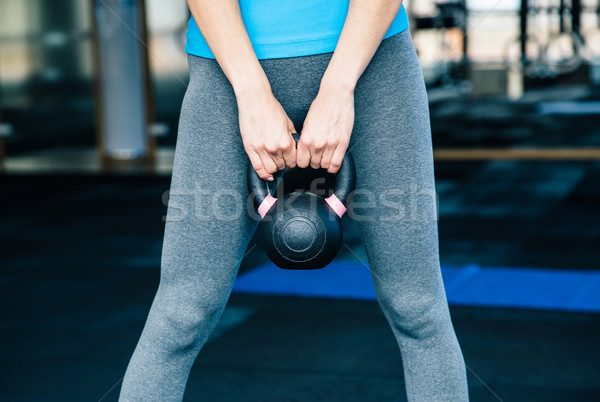 woman working out with kettle ball Stock photo © deandrobot