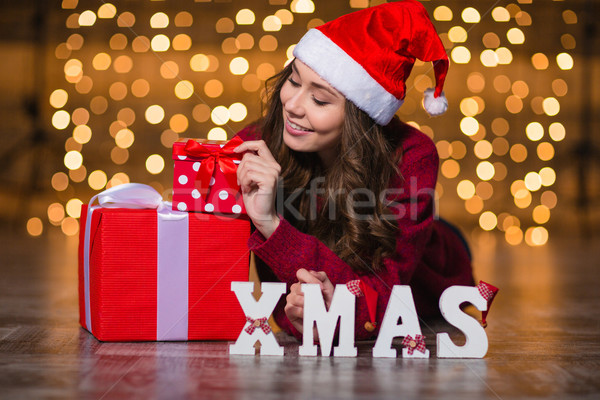 Attractive woman lying near letters spelling word Xmas and presents Stock photo © deandrobot