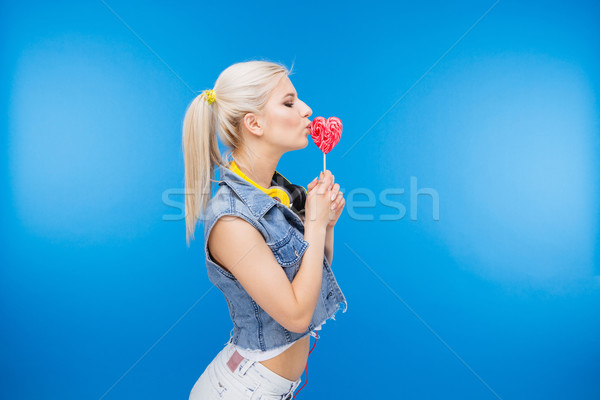 Beautiful female teenager holding lollipop Stock photo © deandrobot
